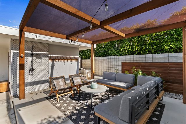 a view of an outdoor sitting area with furniture and umbrella