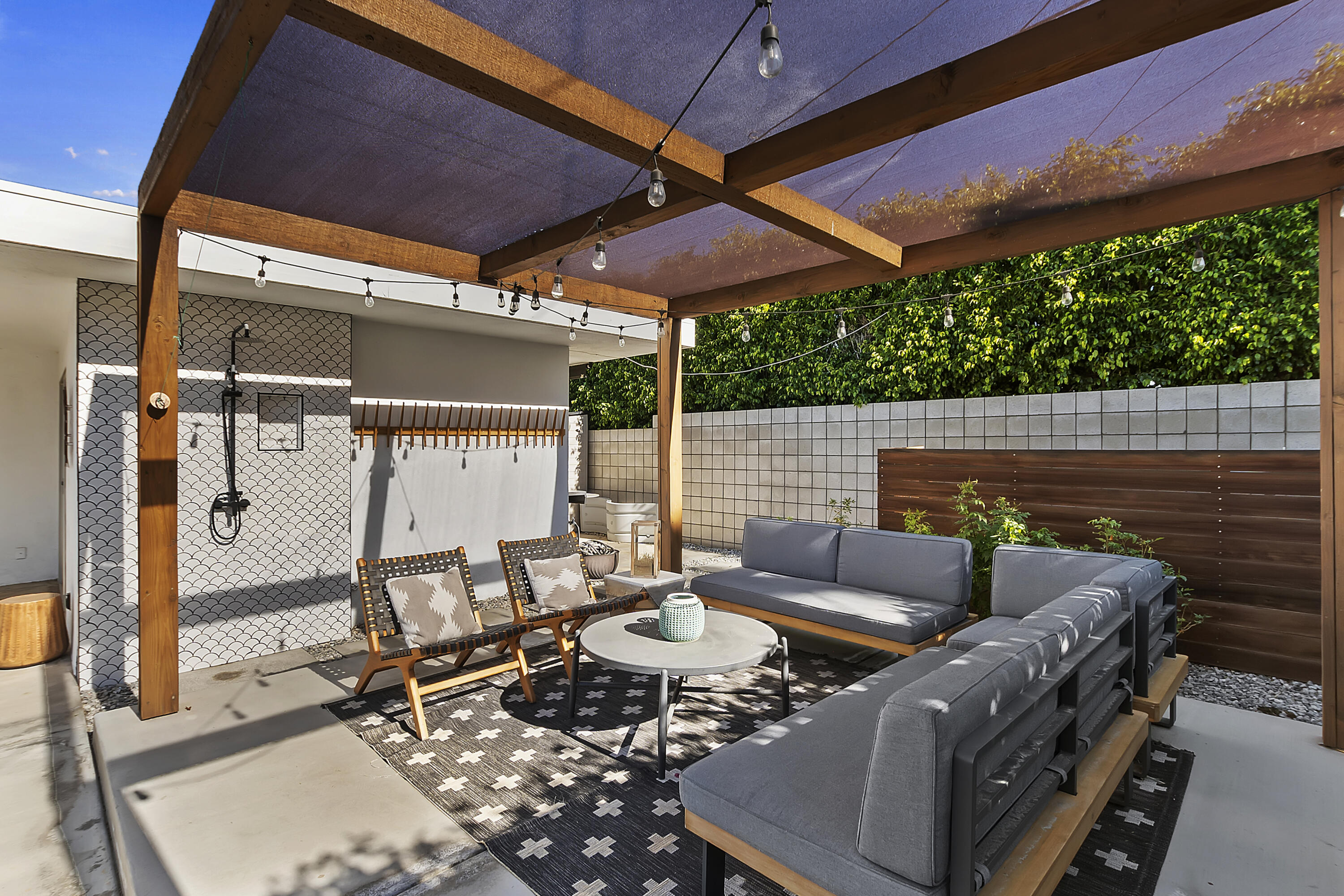 45876 Abronia Trail Palm Desert, CA 92260 - Photo 23 of 26 a view of an outdoor sitting area with furniture and umbrella