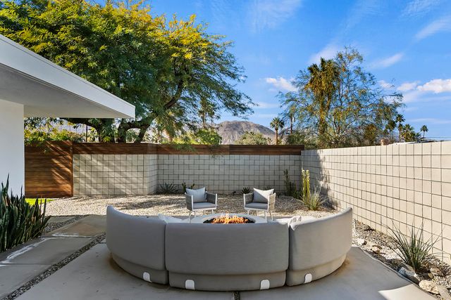 a view of outdoor sitting area with fire pit