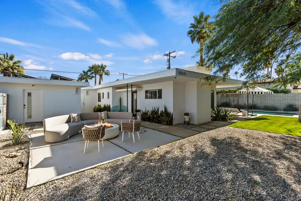 a swimming pool with outdoor seating and yard