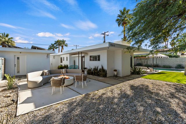 a swimming pool with outdoor seating and yard