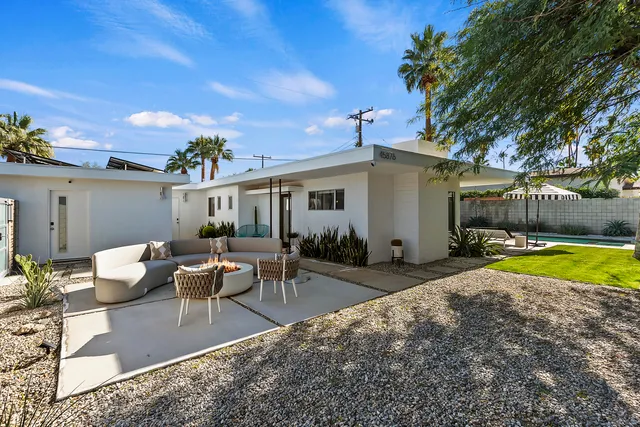 a swimming pool with outdoor seating and yard