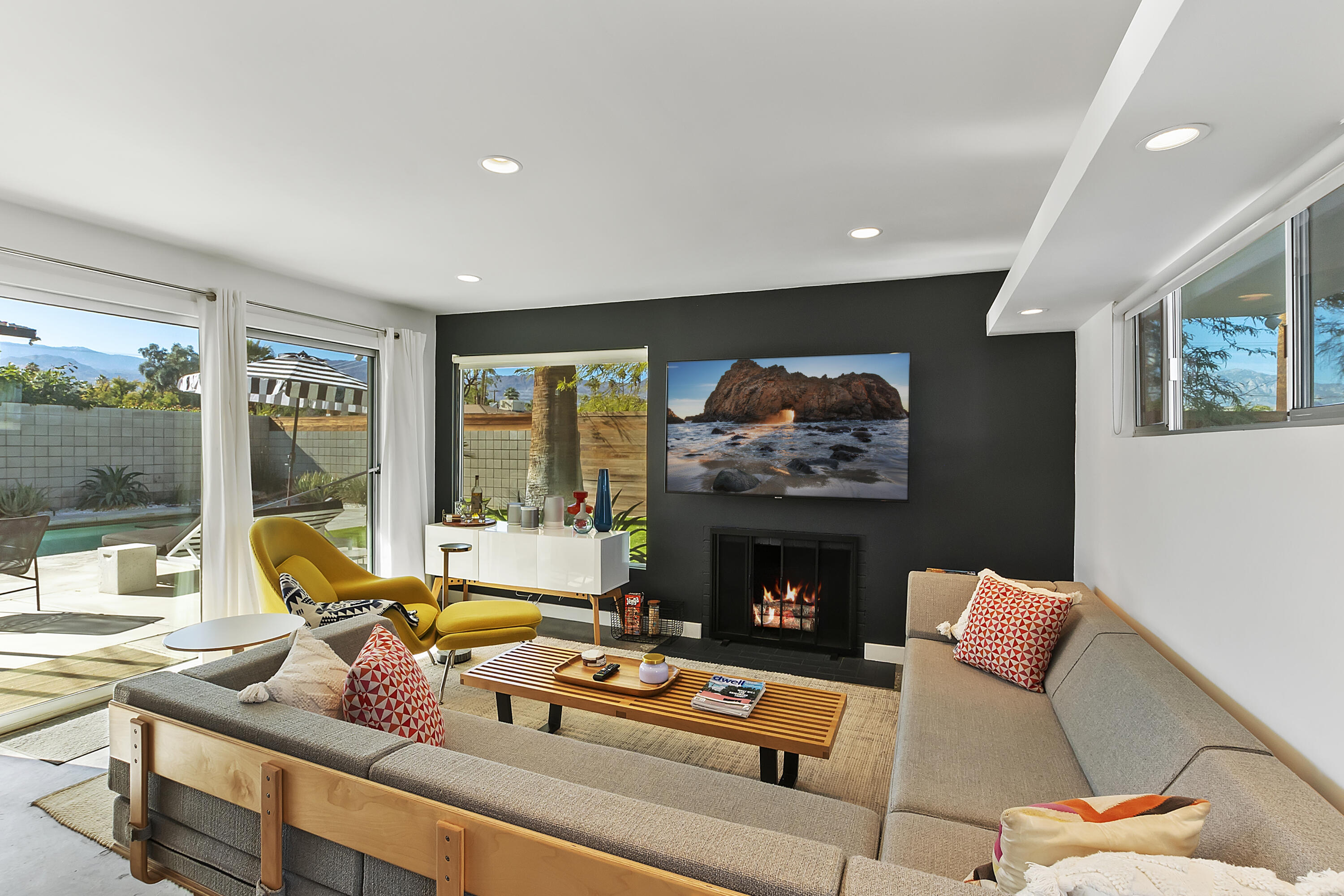 45876 Abronia Trail Palm Desert, CA 92260 - Photo 7 of 26 a living room with furniture a fireplace and a flat screen tv