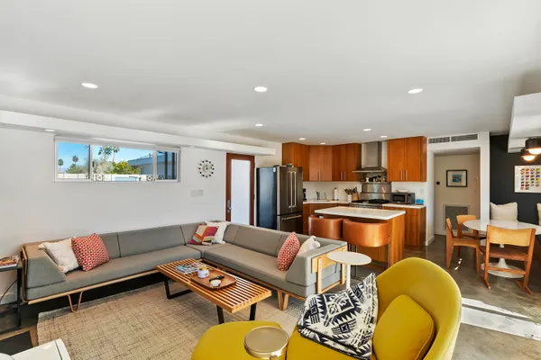 a living room with furniture and a wooden floor