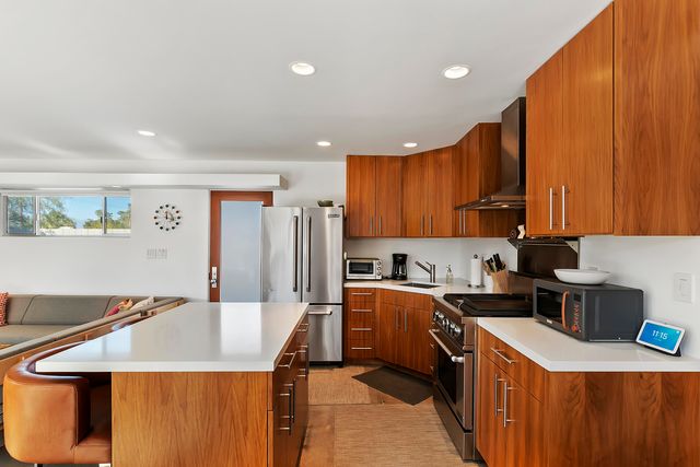 a kitchen with a sink a stove and cabinets
