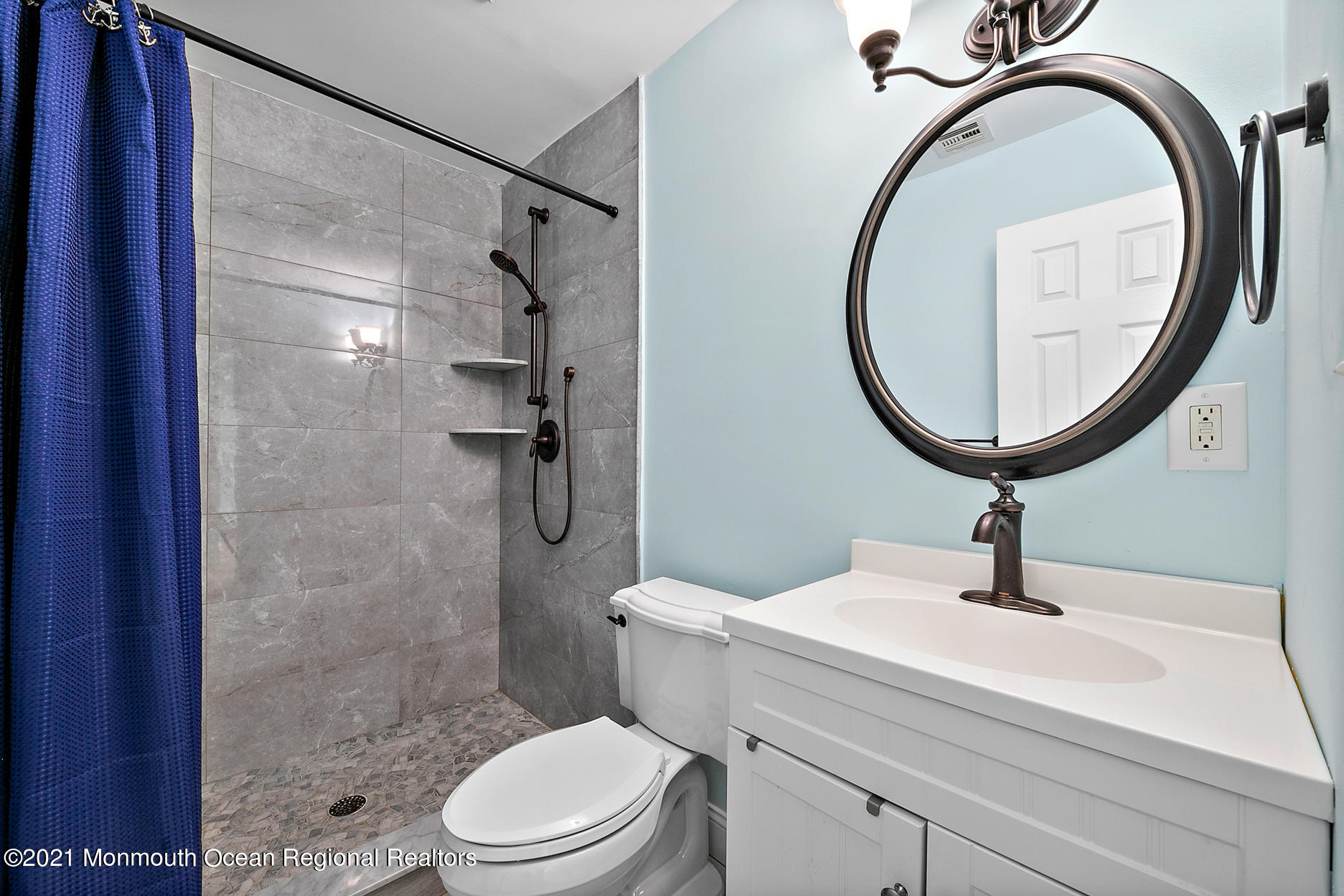 94 Jackson Street Fair Haven, NJ 07704 - Photo 26 of 83 a bathroom with a sink a mirror a toilet and a glass door