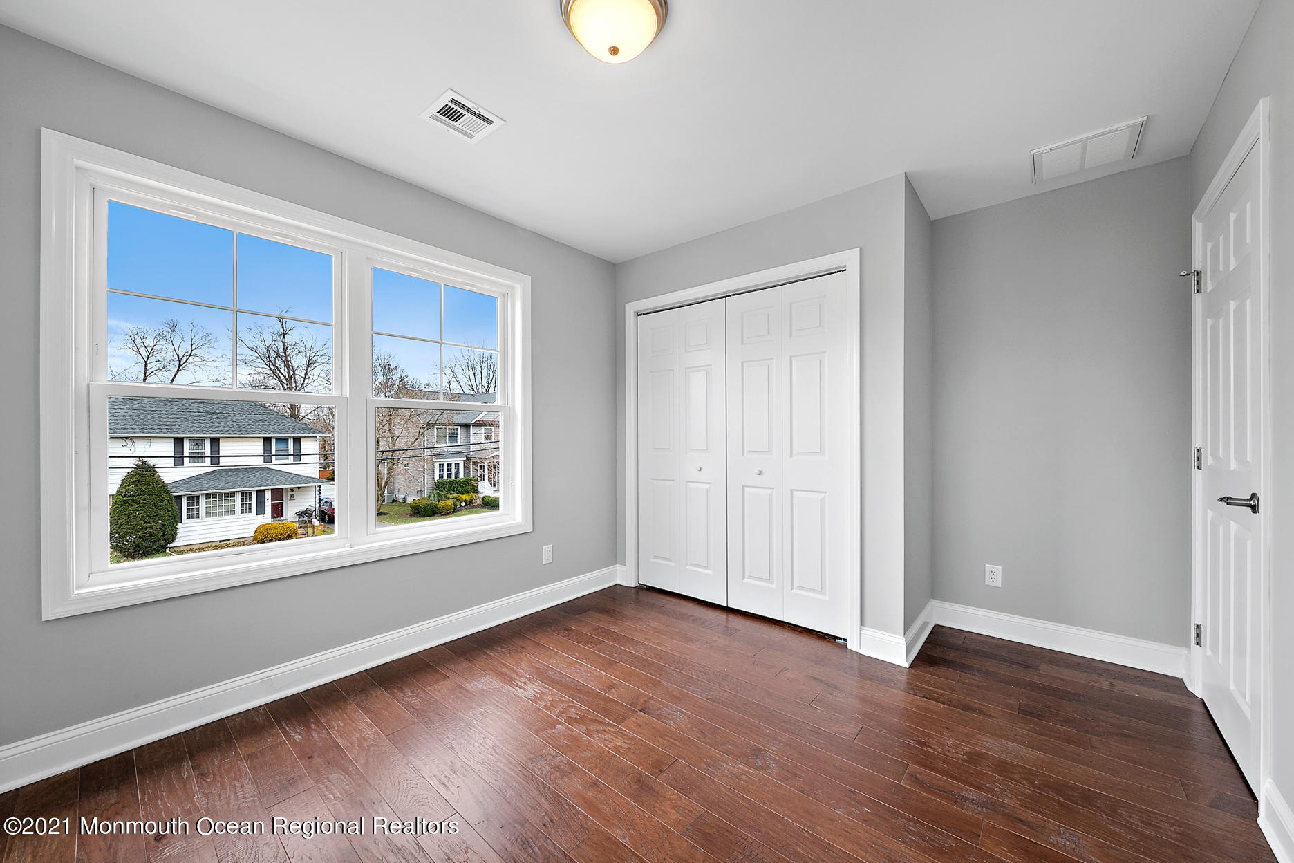 94 Jackson Street Fair Haven, NJ 07704 - Photo 37 of 83 a view of an empty room with a window and wooden floor