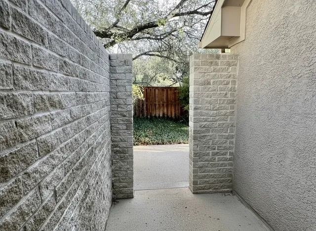 a street view with wooden fence and trees