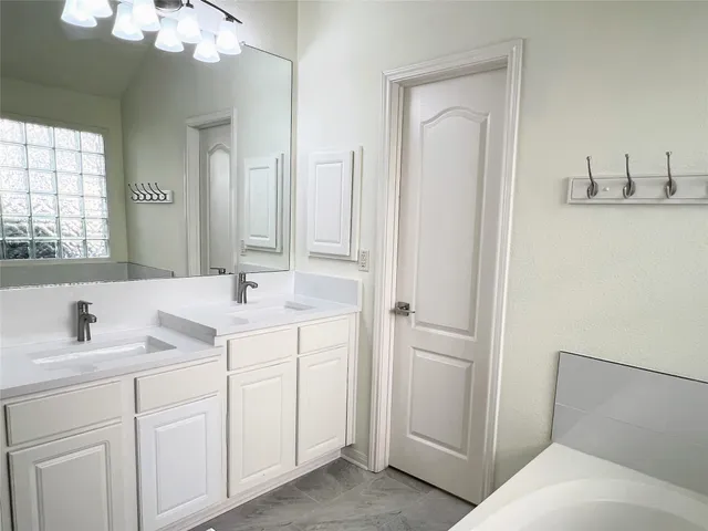 a white bath tub sitting next to a window