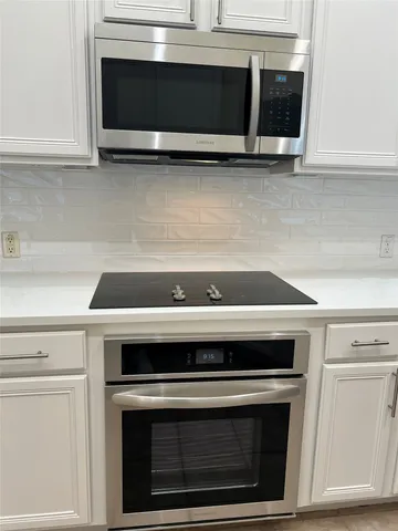 a stove top oven sitting inside of a kitchen