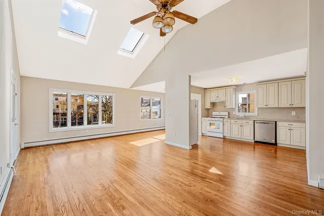 a view of a kitchen with wooden floor and a kitchen space
