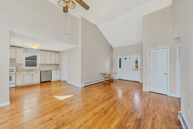 a view of a kitchen with wooden floor and a sink