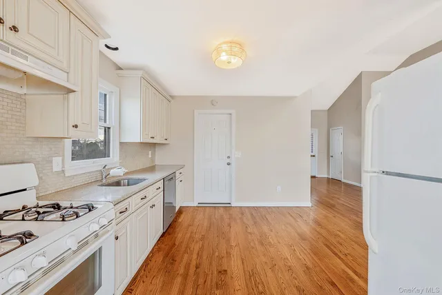 a kitchen with a sink and a stove top oven