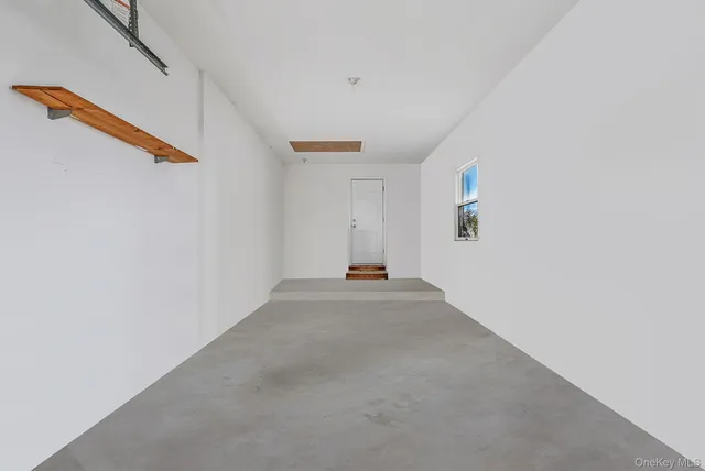 a view of a livingroom with wooden floor and white walls