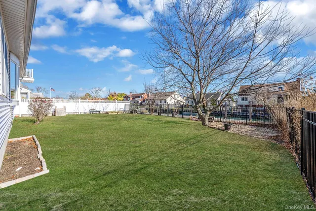 a view of yard with swimming pool and green space