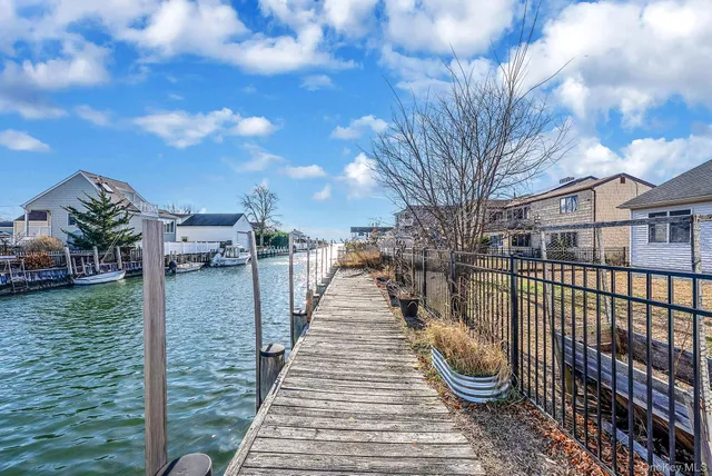 a view of a pathway with a wrought fence