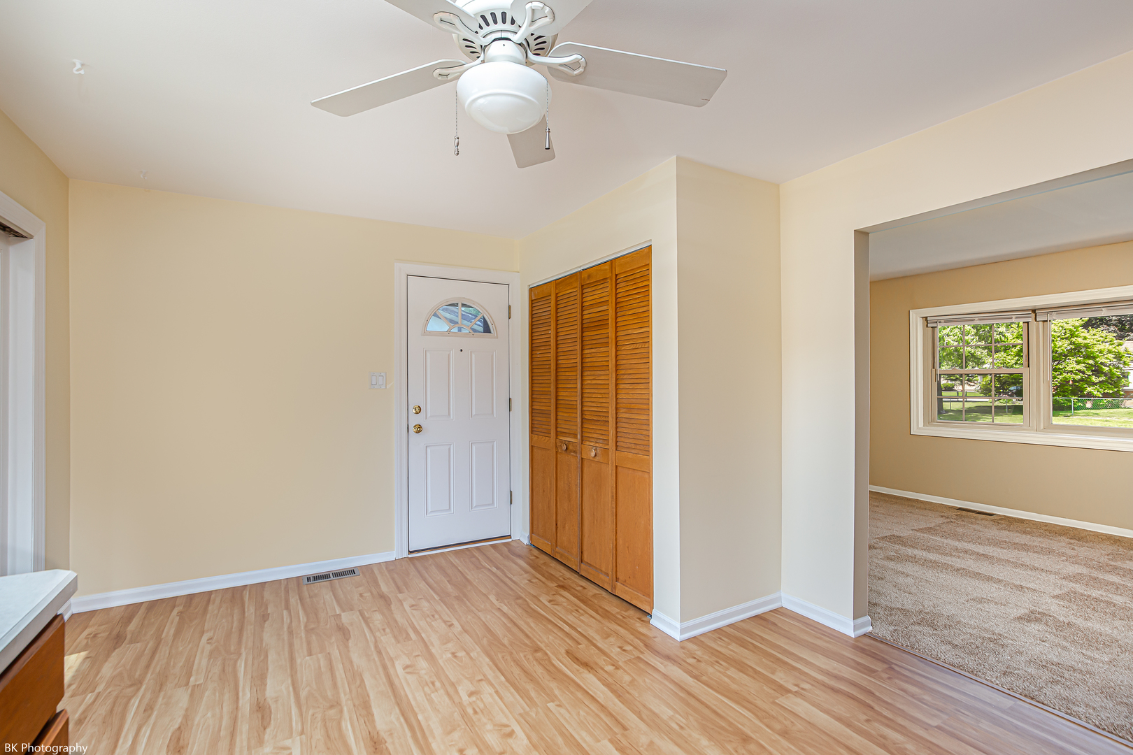 7049 West 91st Street Bridgeview, IL 60455 - Photo 8 of 25 an empty room with wooden floor chandelier fan and windows