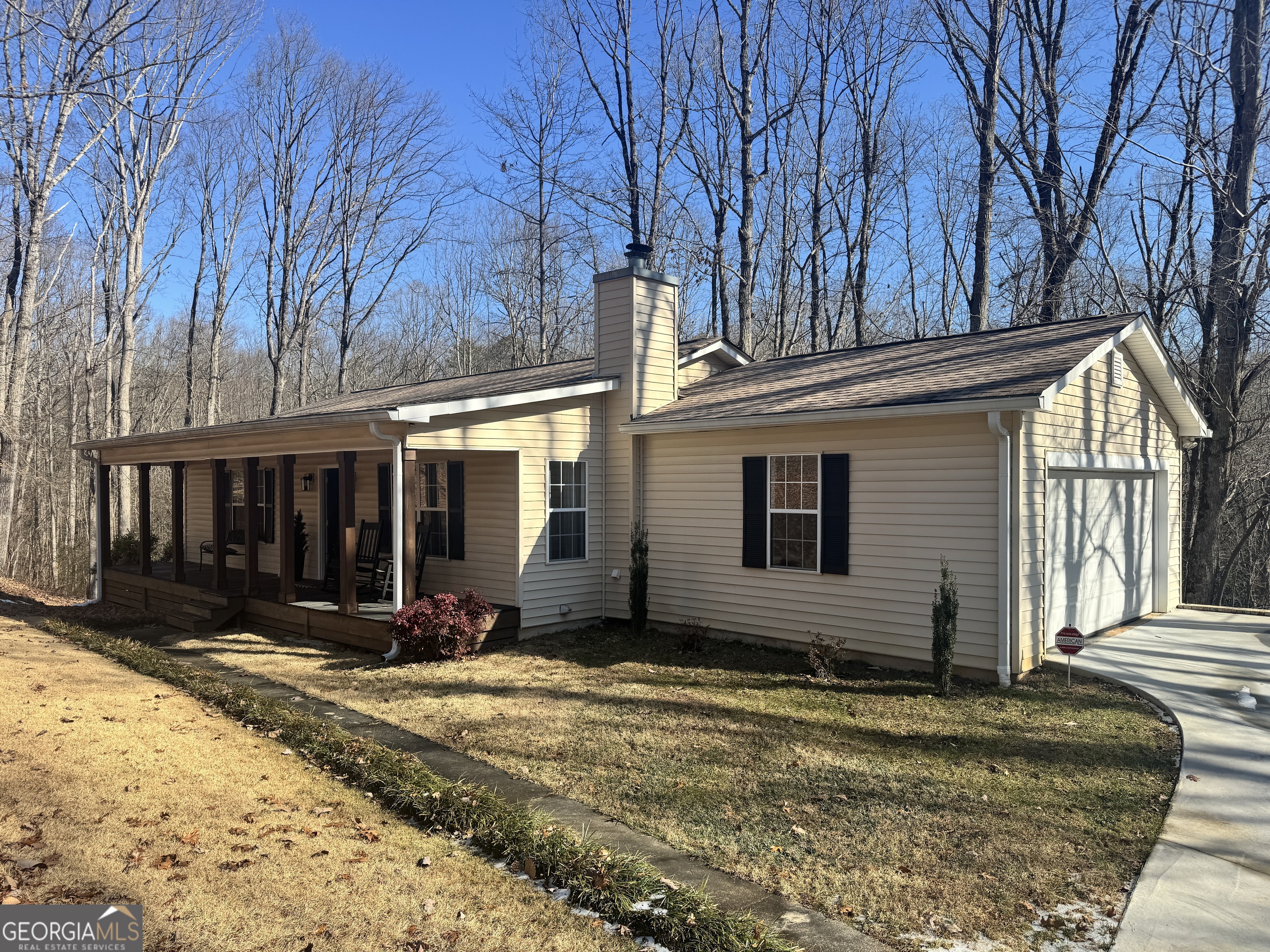 5644 Woodlin Road Lula, GA 30554 - Photo 1 of 1 a view of a house with a yard covered with snow on the road