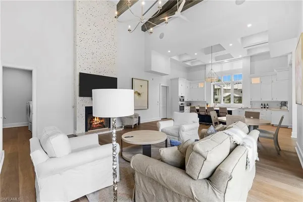 a living room with furniture a rug and white walls