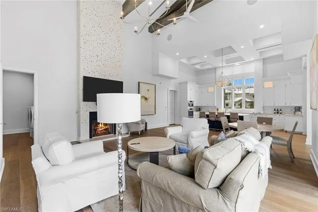 a living room with furniture a rug and white walls