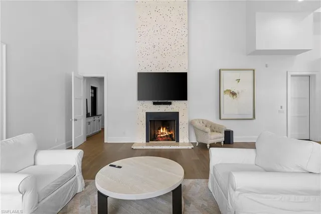 a living room with furniture a fireplace and a flat screen tv