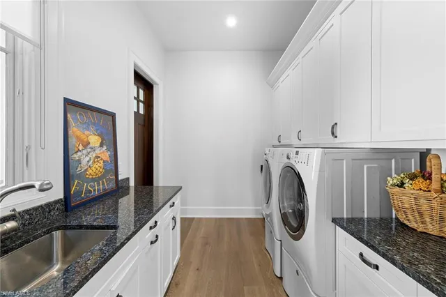 a kitchen with granite countertop a sink and a stove top oven