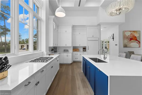 a kitchen with a sink stove and cabinets