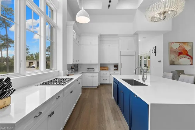 a kitchen with a sink stove and cabinets