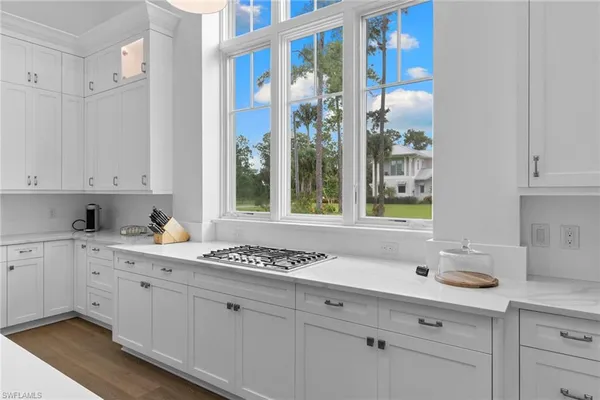 a kitchen with granite countertop a stove and a window