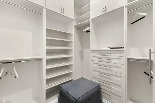 a view of walk in closet with empty racks