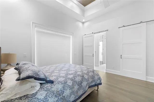 a bedroom with a large bed and a shower