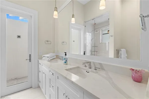 a bathroom with a tub sink and mirror