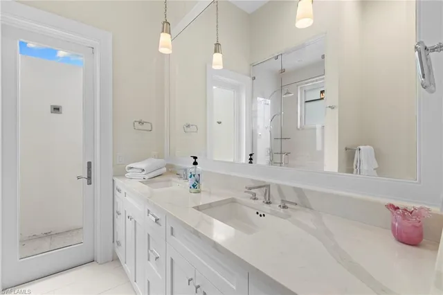 a bathroom with a tub sink and mirror