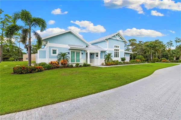 a front view of house with yard and green space