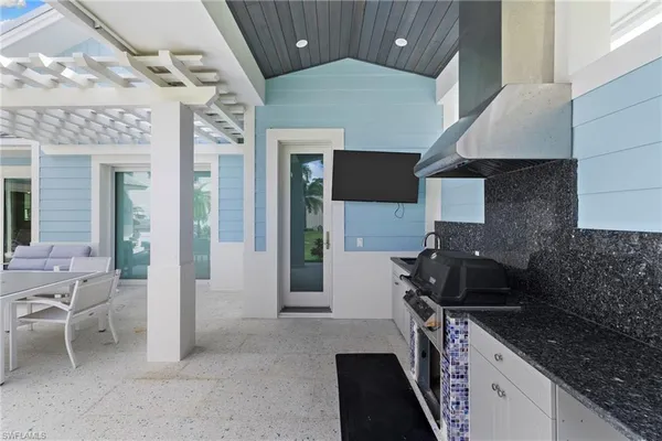 a kitchen with a sink stove and cabinets