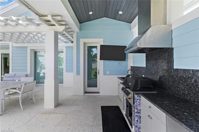 a kitchen with a sink stove and cabinets