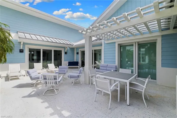 a view of a patio with dining table and chairs