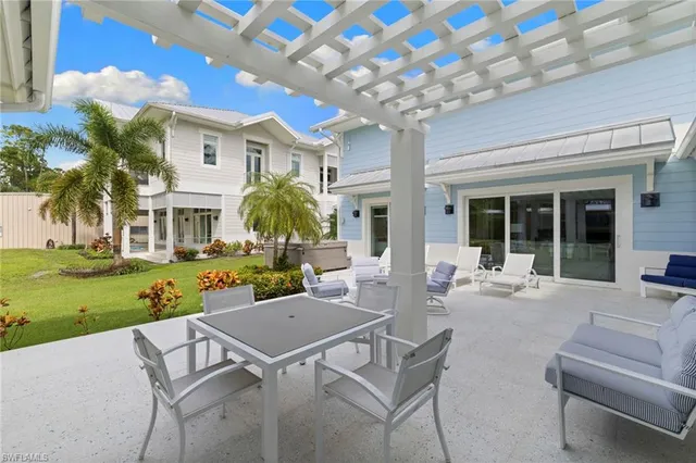 a view of a patio with couches table and chairs with garden view