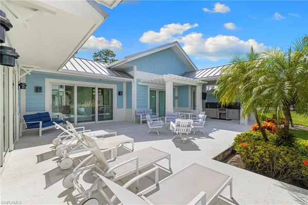 a view of a patio with table and chairs and potted plants