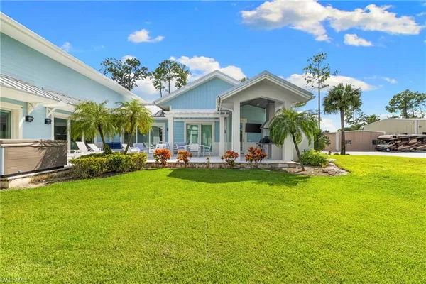 a view of a house with swimming pool and porch with furniture