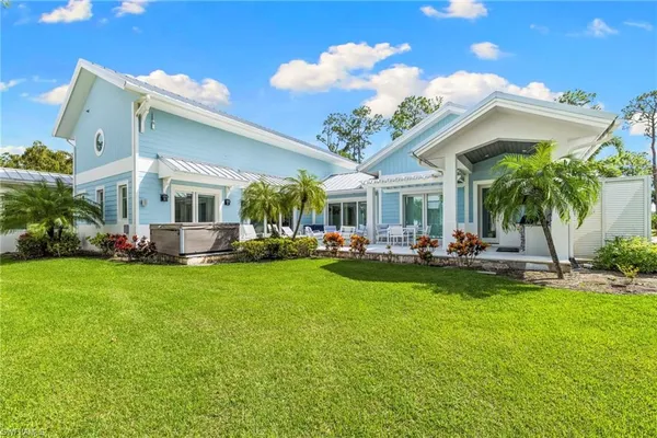 a view of an house with backyard porch and sitting area