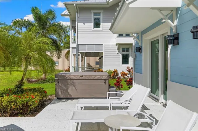 a view of a patio with table and chairs and potted plants