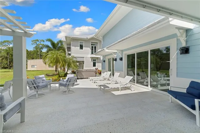 a view of a patio with a dining table and chairs with wooden floor