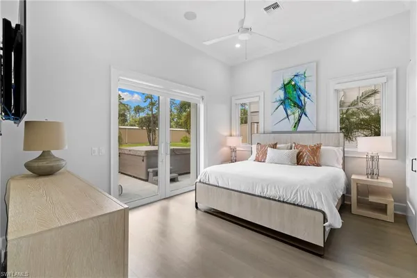 a bedroom with a bed and large window