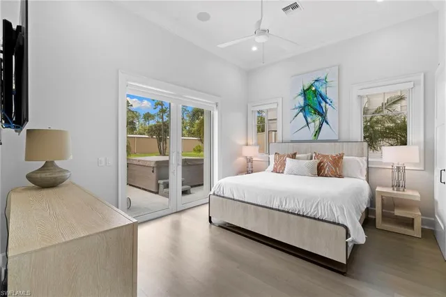 a bedroom with a bed and large window