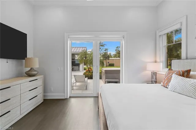 a bedroom with a bed and a flat tv screen on the dresser