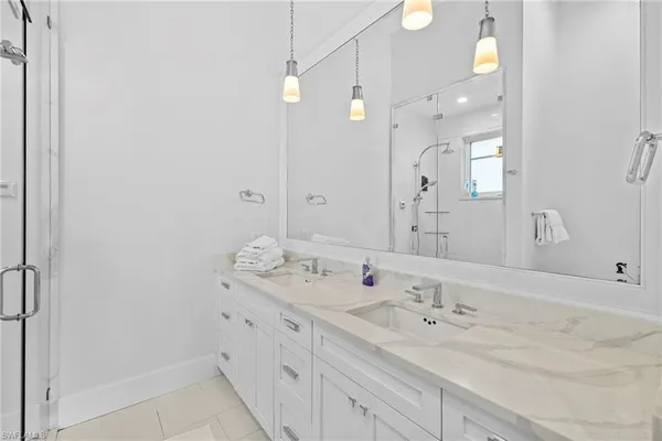 a bathroom with a granite countertop sink mirror and double
