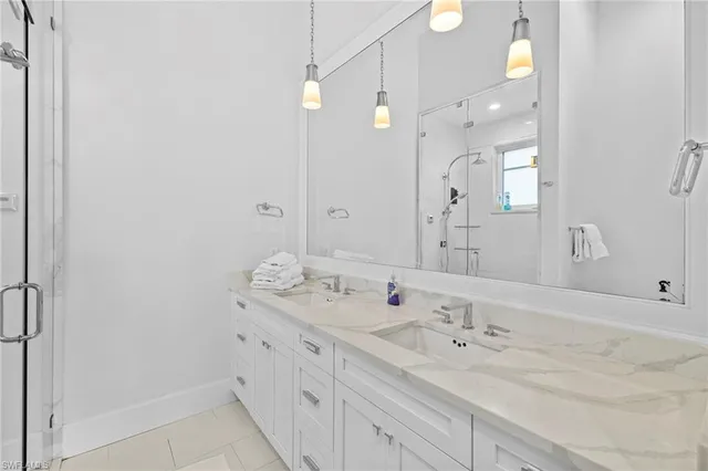 a bathroom with a granite countertop sink mirror and double