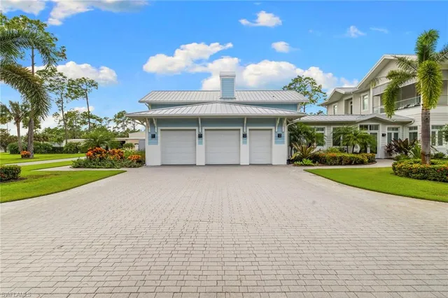 a view of a house with a yard and potted plants