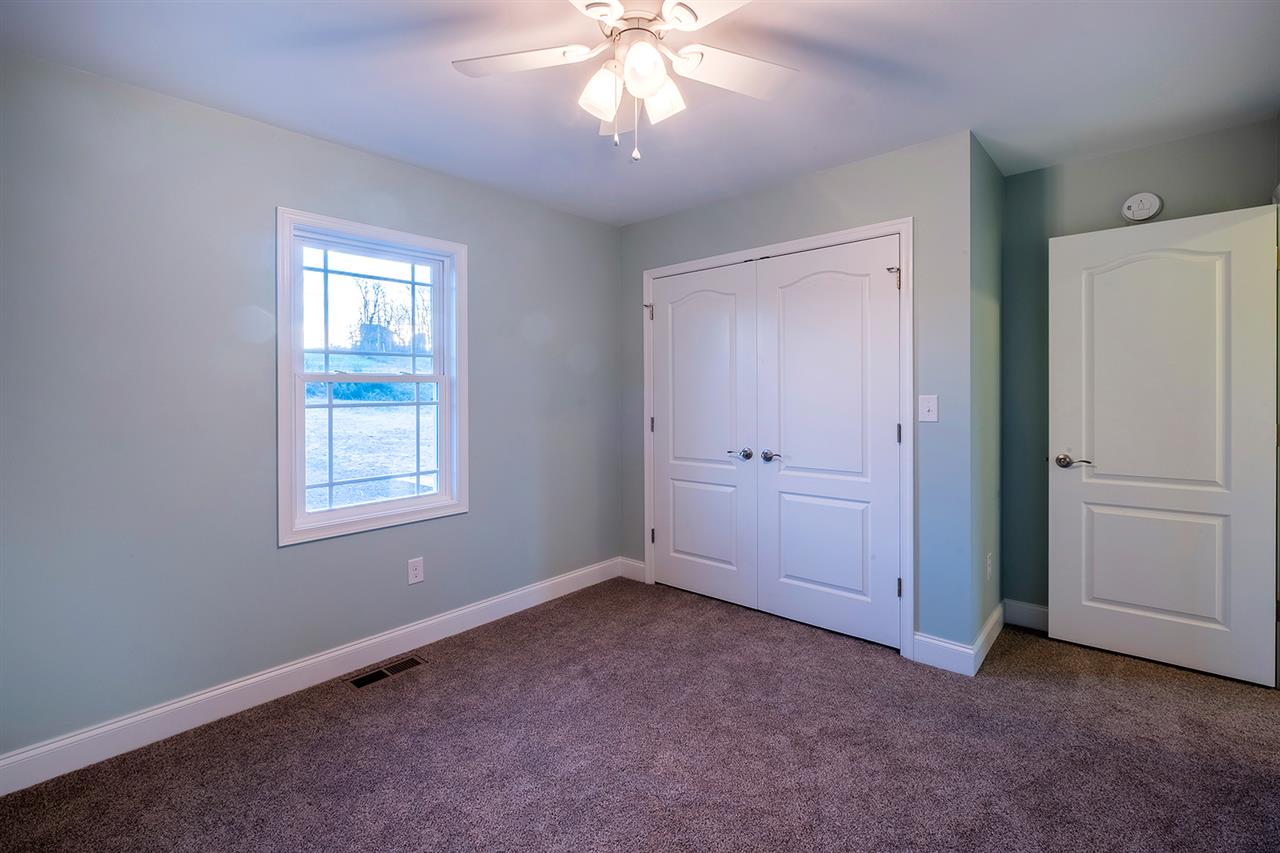 8 North Point School Road Waynesboro, VA 22980 - Photo 15 of 40 an empty room with windows and chandelier fan